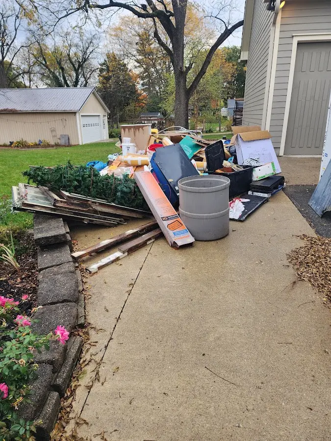 Dumpster being loaded with debris for 12 Yard Dumpster Rental in Bayonet Point